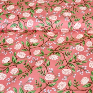 May include: Pink fabric with a white floral pattern. The flowers are stylized and resemble peonies. The fabric has a subtle texture.