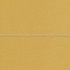 May include: A solid gold fabric with a subtle texture. A&A Cotton Creations is printed at the bottom of the image.