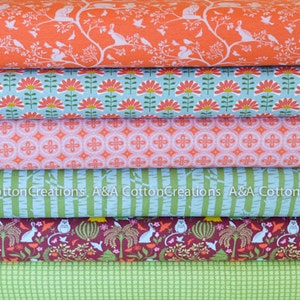 May include: A stack of six fabric panels with different patterns. The patterns include a floral design, a geometric design, a striped design, a woodland design, and a checkered design. The fabrics are in shades of green, red, pink, and blue.