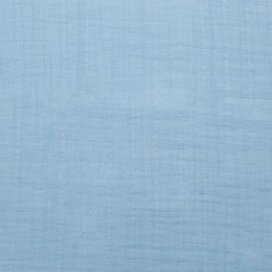 May include: A light blue fabric with a textured surface.