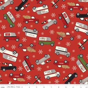 May include: Red fabric with a repeating pattern of vintage delivery trucks with Christmas themes. The trucks are in various colours and designs, including red, green, white, and black. Some trucks have Christmas trees, flowers, and the words "Deliver Joy", "Noel", "Post", and "Hol  Meaated".