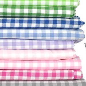 May include: A stack of 10 different colored gingham fabrics. The colors are red, yellow, green, blue, light blue, purple, pink, hot pink, gray, and black.