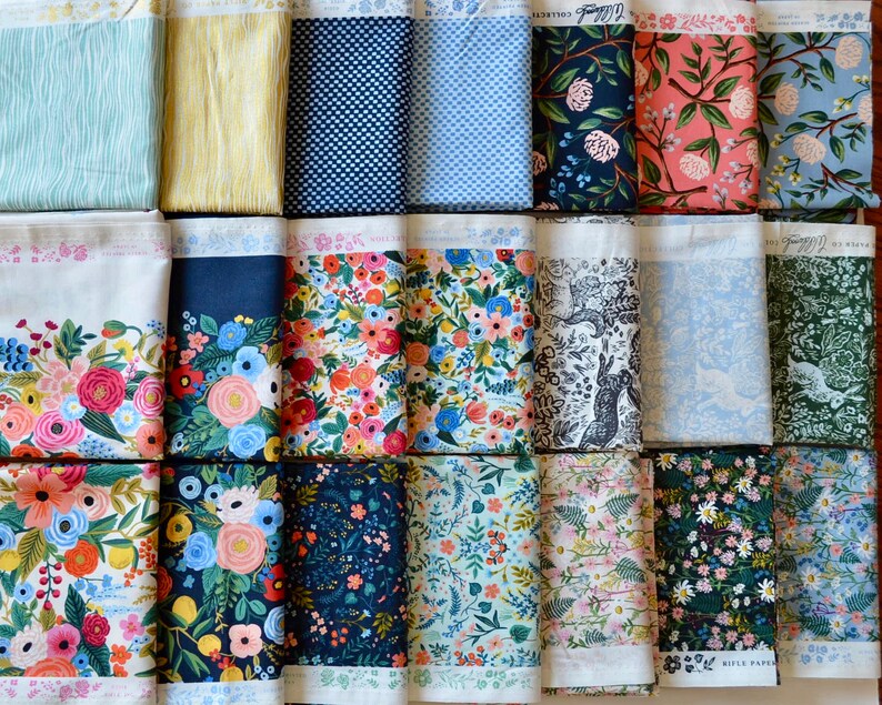 May include: A collection of 18 fabric swatches featuring floral, geometric, and animal print designs. The fabrics are in various colors, including blue, green, pink, and white. The fabric swatches are arranged in three rows of six.