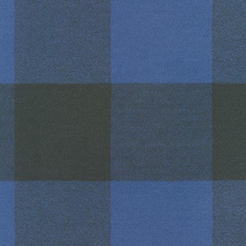 May include: A close-up of a fabric with a large blue and black plaid pattern. The squares are evenly sized and create a bold, graphic design. The fabric has a slightly textured appearance.