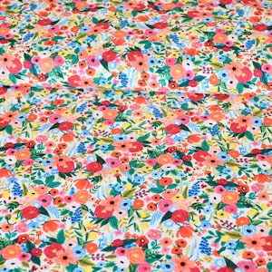 May include: Floral fabric with a white background, featuring a dense pattern of colorful flowers. The design includes red, pink, blue, and yellow blossoms with green foliage. The fabric is suitable for various sewing and crafting projects.