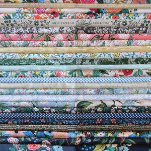 May include: A stack of colorful fabric featuring floral patterns and the text "Rifle Paper Co. Wildwood Collection".