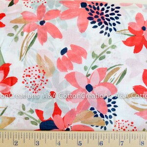 May include: White cotton fabric with a pink and red floral print. The flowers are stylized and have a watercolor effect. The background is white with a subtle texture.