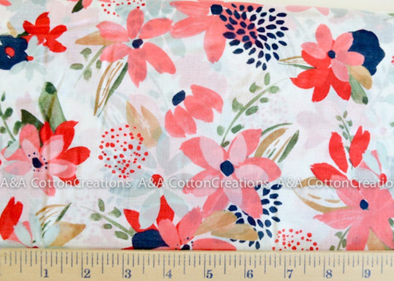 May include: White cotton fabric with a pink and red floral print. The flowers are stylized and have a watercolor effect. The background is white with a subtle texture.