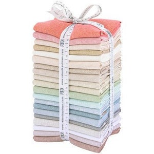 May include: A stack of 20 fabric squares in various shades of beige, pink, green, and blue. The fabric is a linen blend and has a subtle texture. The squares are tied together with a white ribbon and a measuring tape.