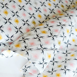 May include: White cotton fabric with a repeating pattern of black birds flying in a diagonal direction. The background has a repeating pattern of yellow and pink stars.