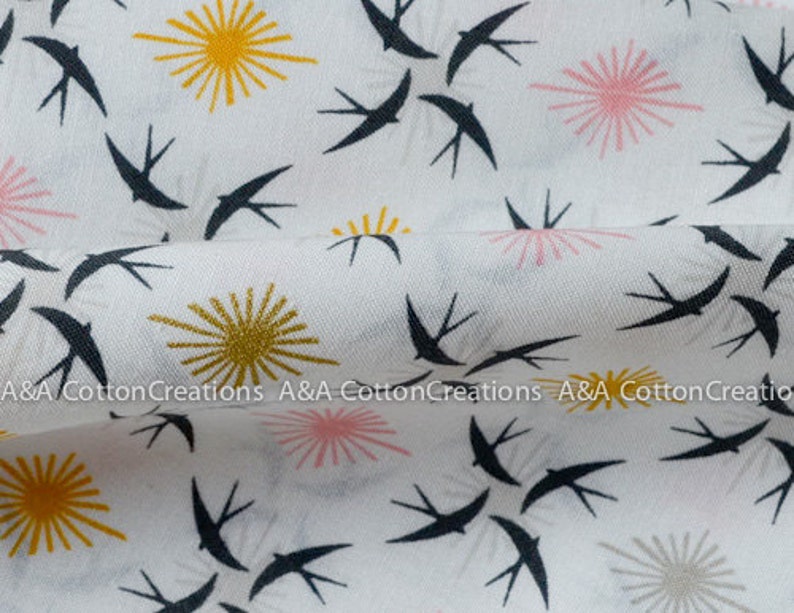 May include: White fabric with a repeating pattern of black swallows and stylized sunbursts in yellow, pink, and gray.