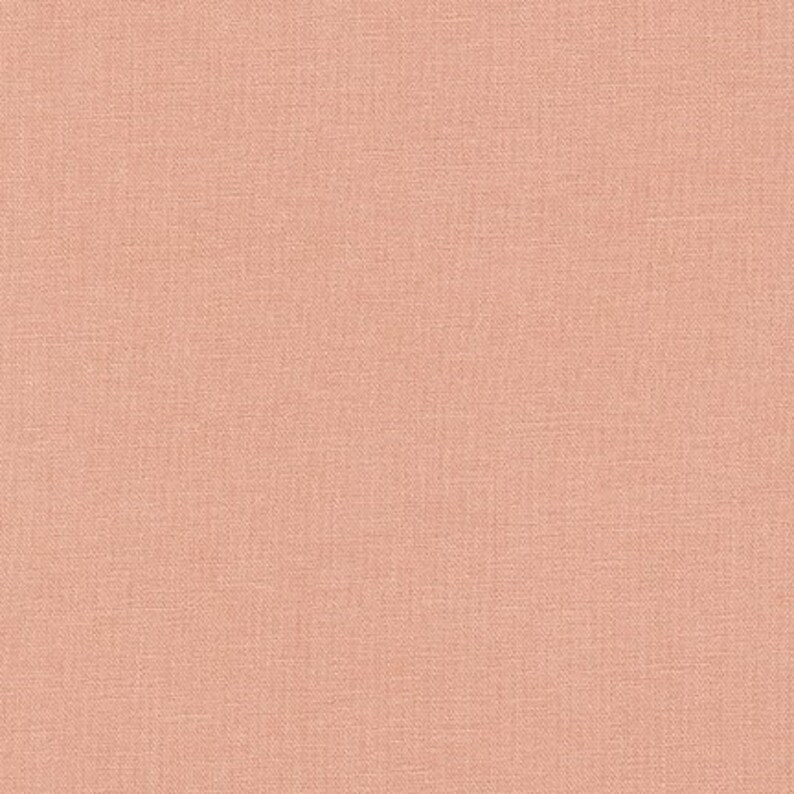 Puede incluir: Una tela de color melocot&oacute;n s&oacute;lido con una textura tejida sutil.