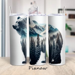 May include: Three white insulated tumblers with a bear and mountain forest design. The bear is depicted in a silhouette with a forest and mountain landscape. Each tumbler has a silver lid and a straw. The word "Pixnaw" is printed at the bottom.