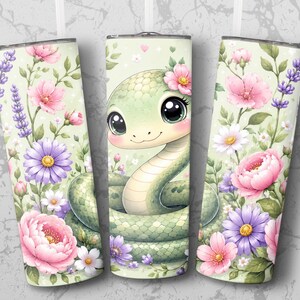 May include: A cylindrical tumbler featuring a light green background with a pattern of pink, purple, and white flowers, including lavender and peonies. A cartoon snake with large black eyes and a light green scaled body is centred on the design.