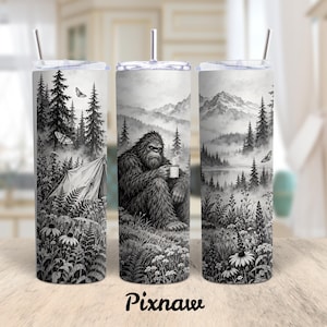 May include: A cylindrical stainless steel tumbler with a clear lid and straw, featuring a black and white graphic print of a Bigfoot creature holding a steaming mug in a forest landscape with a tent, mountains, and butterflies.