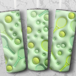May include: Three green insulated tumblers with a tennis theme. The design features tennis balls, rackets, and circular accents in varying shades of green and yellow. The tumblers have a glossy finish and a silver rim.