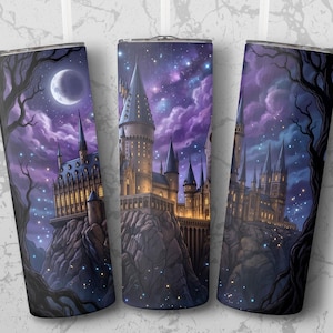 May include: Three stainless steel insulated tumblers with a fantasy castle design. The artwork features a castle on a rocky cliff under a starry night sky with a crescent moon and dark trees. The color palette includes purple, blue, and gold.