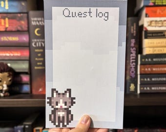 May include: A notepad with the text "Quest log" at the top. A pixelated cat graphic is in the lower left corner. The notepad is held in front of a bookshelf filled with books.