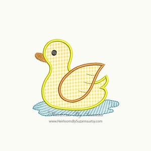 May include: A yellow rubber duck with a gingham pattern, floating in blue water. The duck has a yellow beak and orange feet.