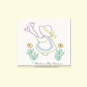 May include: Embroidered design of a girl in a blue dress and hat holding two hearts, with green flowers on either side. The design is titled "Heirlooms By Susanna" with the website address below.