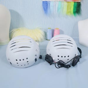 KIG-style inner helmet shell shown with optional USB cooling fans installed in front vents, offering built-in airflow for hot environments. This fursuit liner is perfect for cosplay performers who need comfort and circulation inside mascot heads. The plastic frame is lightweight yet durable, providing support and balance while remaining easy to modify and integrate into custom headgear.