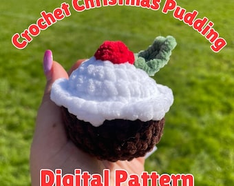 May include: A crocheted Christmas pudding with a white top, brown base, red berry, and green leaf. The text "Crochet Christmas Pudding" and "Digital Pattern" are displayed in red.