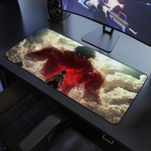 May include: A rectangular mousepad featuring a dramatic scene with a large, red, monstrous figure with glowing eyes looming over a smaller figure. The background is a cloudy sky, creating a sense of scale and conflict.