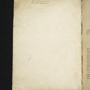 May include: Open book with aged, off-white pages. The left page has faded handwritten text in black ink at the top. The right page has more text in a similar style. The book's edges are worn, suggesting age and use.