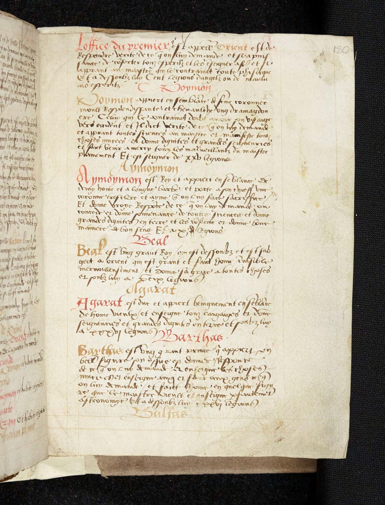 May include: Open book with handwritten text in red and black ink. The aged pages display script in a medieval style, with annotations and headings. The text appears to be a religious or historical document.
