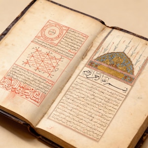 May include: A white ceramic mug with a black handle and the text "But First, Coffee" in a bold, black font. The mug is sitting on a wooden surface.