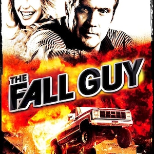 May include: Movie poster for "The Fall Guy" featuring two people, a man and a woman, above the title. A truck is mid-air in front of an explosion. The poster has a vintage, action-movie aesthetic.