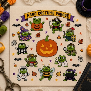 May include: A cross-stitch pattern titled Frog Costume Parade featuring ten green frogs in various Halloween costumes, including a pumpkin, pirate, wizard, knight, detective, cowboy, scientist, astronaut, bee, and ninja, surrounding a large orange jack-o'-lantern.
