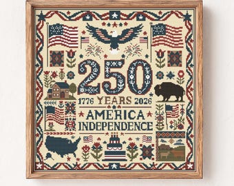 May include: Framed cross-stitch celebrating 250 years of American Independence. The design features the American flag, an eagle, a bison, and the text "America Independence" with the years 1776 and 2026. The color palette includes red, white, blue, and brown.