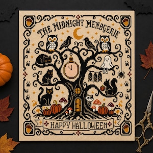 May include: A cross-stitch pattern on beige fabric featuring a black tree with owls, cats, a ghost, bats, and pumpkins. The text reads THE MIDNIGHT MENAGERIE and HAPPY HALLOWEEN. The design includes a crescent moon, stars, and acorns in the corners.