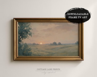 May include: A framed landscape painting with a golden frame. The artwork depicts a sunset over a field with a tree on the left side. The text "DOWNLOADABLE FRAME TV ART" is in a black oval. The text "COTTAGE LANE PRINTS vintage inspired art" is at the bottom.