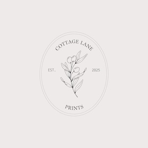 May include: A black and white oval logo featuring a central line drawing of a leafy olive branch. The text COTTAGE LANE is arched at the top, PRINTS is at the bottom, and EST. 2025 is positioned on the left and right sides of the central illustration.