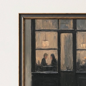 May include: A framed oil painting depicting a dark storefront exterior with large glass windows. Inside, two figures sit at a table illuminated by warm, glowing pendant lights and a candle. The scene features a black frame with gold trim details.