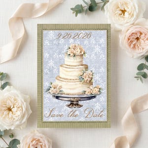 May include: A rectangular Save the Date card featuring a three-tiered wedding cake on a silver pedestal, decorated with cream-colored flowers. The background is a light blue damask pattern. The text 9.26.2026 and Save the Date are printed in gold.