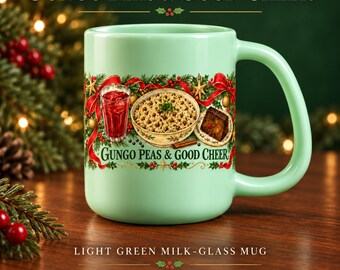 May include: A light green milk-glass mug featuring a festive holiday graphic of a bowl of gungo peas, a glass of red drink, and a slice of fruitcake surrounded by holly and red ribbons, with the text Gungo Peas & Good Cheer printed on the front.