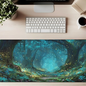 May include: A rectangular desk mat featuring a fantasy forest scene. The artwork depicts a path leading into a glowing, teal-colored forest with large trees and sparkling lights. The mat is surrounded by a black border.