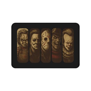 Horror icons desk mat featuring lineup of classic scary movie villains illustrated in dark creepy style Oversized gaming mouse pad with stitched edges non slip rubber backing and smooth premium surface Perfect spooky desk accessory for gamers students and horror fans Adds creepy Halloween inspired decor to workspace setups Unique gift idea for scary movie lovers birthdays or Halloween Functional stylish oversized desk mat with chilling villain artwork