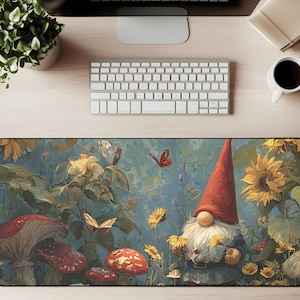 May include: A whimsical desk mat featuring a garden gnome with a red hat, surrounded by sunflowers, mushrooms, and butterflies. The mat has a blue background with a painted aesthetic, perfect for a home office or workspace.