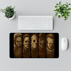 Horror Icons Desk Mat – Add spooky vibes to your desk with this chilling design featuring classic horror villains illustrated in dark detail. Perfect for Halloween lovers, horror fans, and gamers who enjoy creepy and bold desk decor. This oversized mat doubles as both a gaming mouse pad and an eye-catching workspace accessory