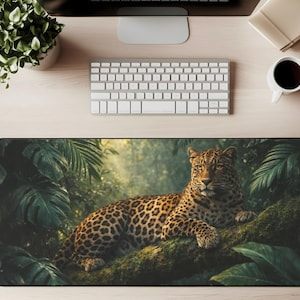May include: A rectangular desk mat featuring a detailed image of a leopard resting on a mossy tree branch in a lush jungle setting. The leopard has a spotted coat and is surrounded by green foliage.