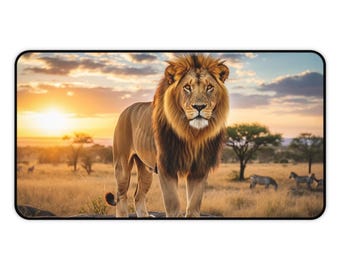 May include: A rectangular mousepad depicting a lion in a savanna scene at sunset. The lion has a brown mane and is standing on a rock. Zebras and trees are visible in the background.