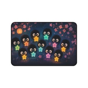 Soot Sprites Desk Mat featuring Susuwatari soot creatures holding glowing neon stars against a dreamy night sky with cherry blossoms Perfect Japan decor for anime fans and a thoughtful gift for Japanese anime lover Large gaming mousepad design is inspired by Spirited Away Ghibli and Miyazaki fan art Smooth surface ensures accurate mouse control while durable non slip backing keeps it in place Magical desk mat for gaming setups or offices