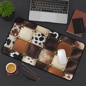 May include: A rectangular mousepad with a patchwork design featuring squares of faux leather and animal print patterns in shades of brown, tan, and cream. The squares are accented with gold-colored studs.