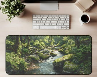 May include: A rectangular desk mat featuring a detailed landscape painting of a river flowing through a lush forest. The artwork showcases green foliage, moss-covered rocks, and a serene water scene. The mat is designed to protect the desk surface.