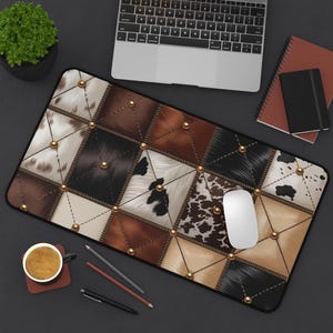 May include: A rectangular mouse pad with a patchwork design featuring various textures and colors, including brown, black, and white faux fur. Gold-colored studs are placed at the intersections of the patches. A white computer mouse rests on the pad.