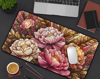 May include: A rectangular mouse mat with a floral design. Large, stylised peonies in pink, cream, and yellow are set against a stained-glass-style background with brown and purple hues. A computer mouse and laptop are visible on the mat.